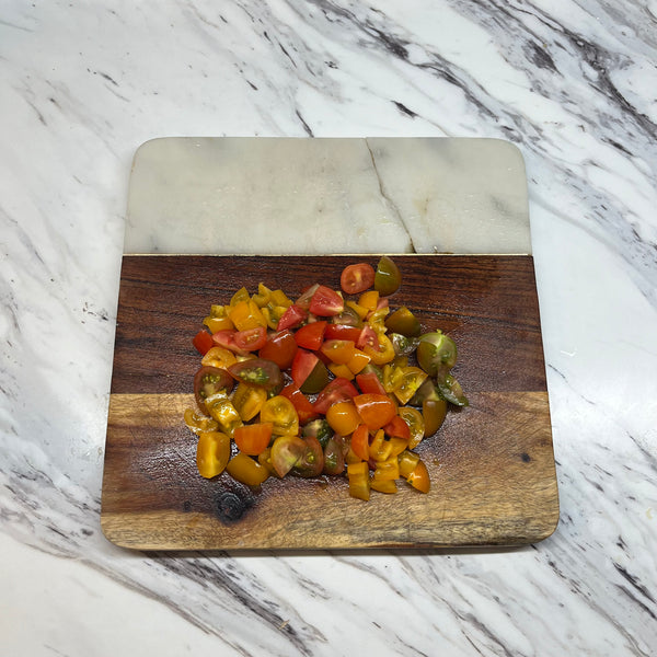 cutting the cherry tomatoes into small pieces