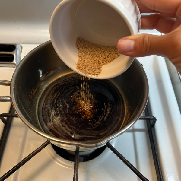 pouring dashi powder into the sauce