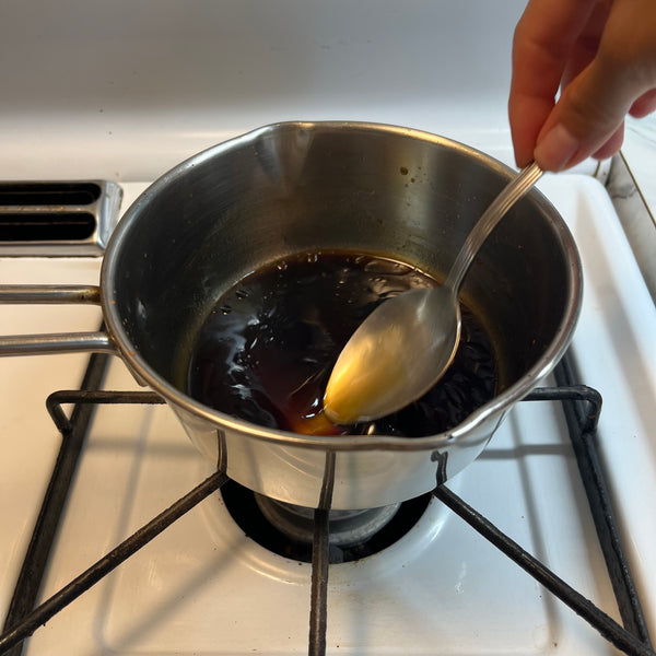 mixing everything together to emulsify the dressing