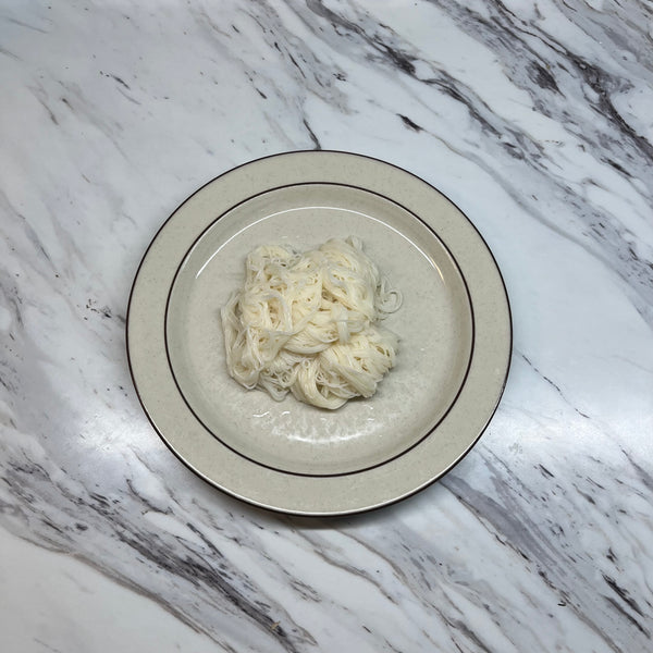 placing the drained somen noodles on a plate