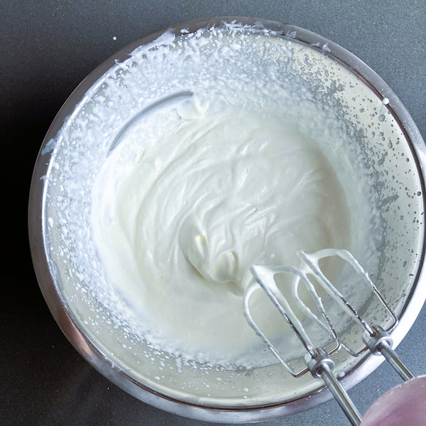 whipping the cream until soft peaks form