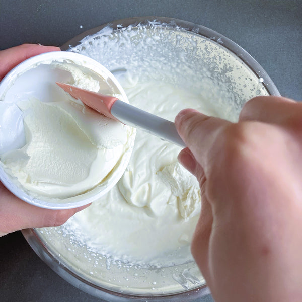 adding the mascarpone cheese to the whipped cream