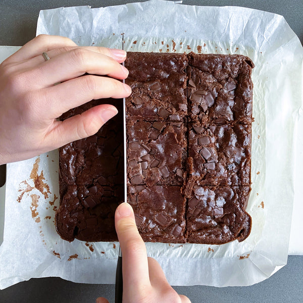 cutting the mochi brownies into 9 pieces