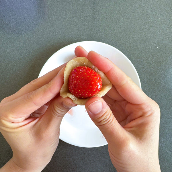 wrapping the strawberry in white bean paste