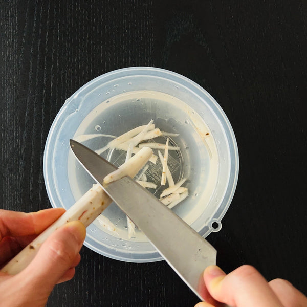 peeling and shaving the burdock root