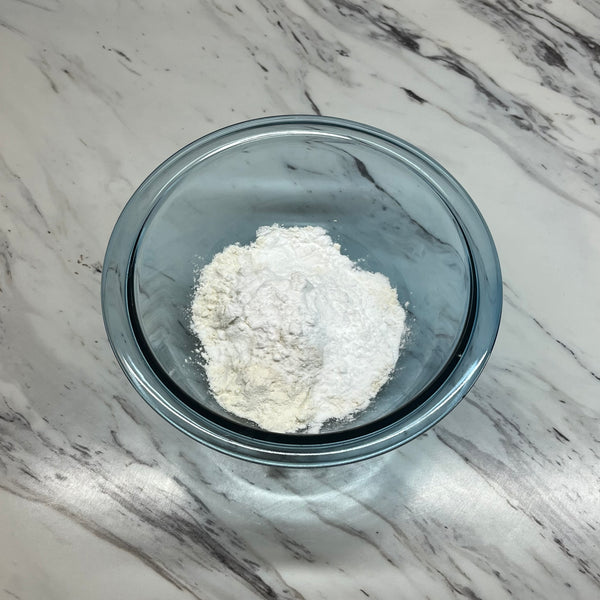 adding the dry ingredients to a bowl