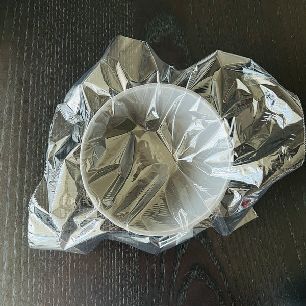 adding a piece of plastic wrap to a bowl