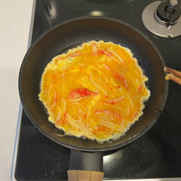 cooking the crab omelet in a frying pan