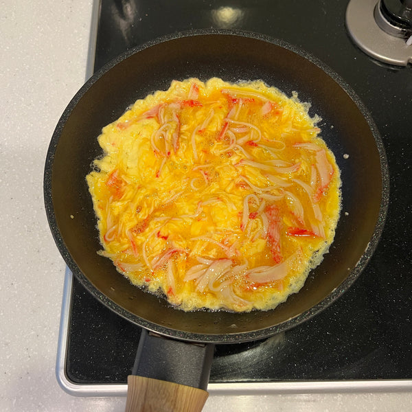 cooking the crab omelet until it has slightly set