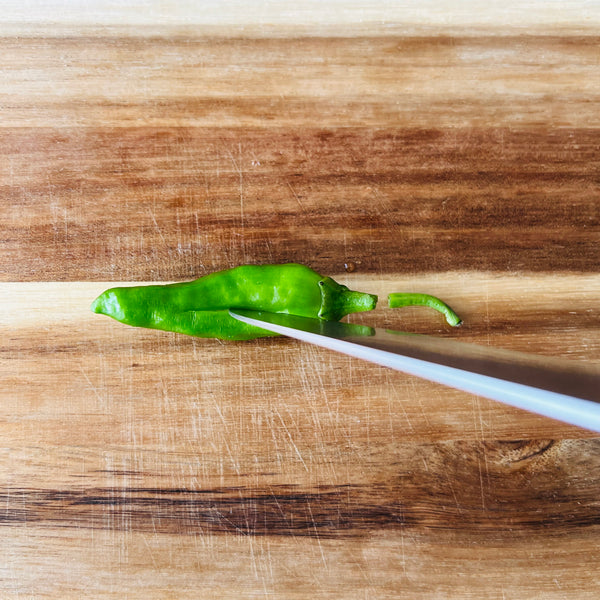 making a slit in the shishito pepper