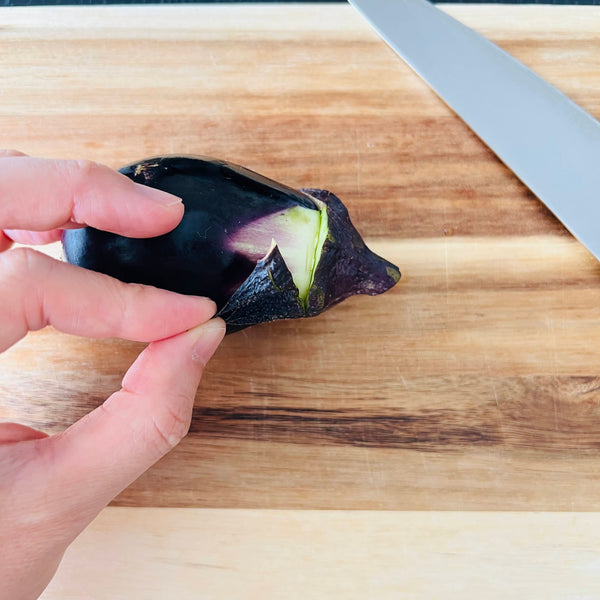 cutting the edges of the eggplant off