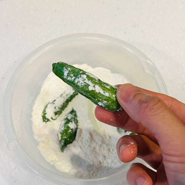 coating the tempura ingredients in flour