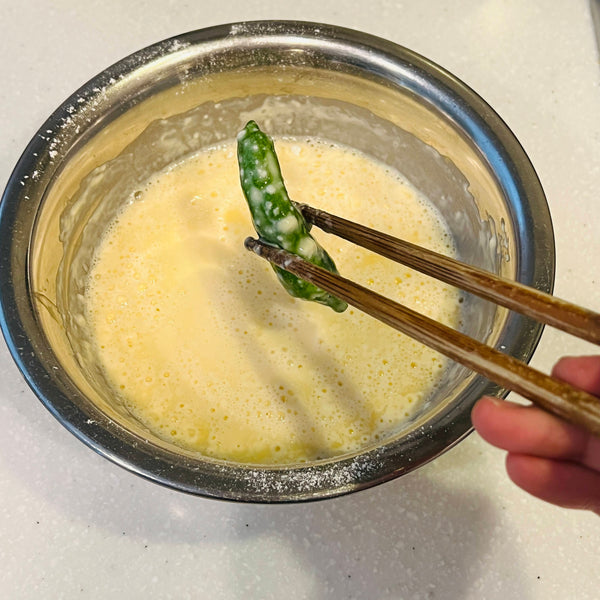 Dipping the Tempura ingredients in the tempura batter