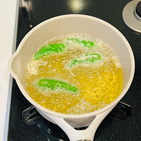 adding the prepared tempura ingredients to the hot oil