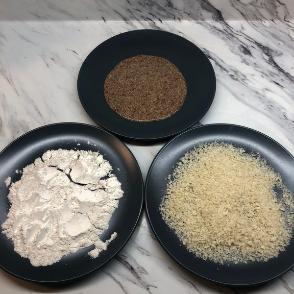 preparing three bowls. one with flour, one with panko breadcrumbs, and one with the flax egg