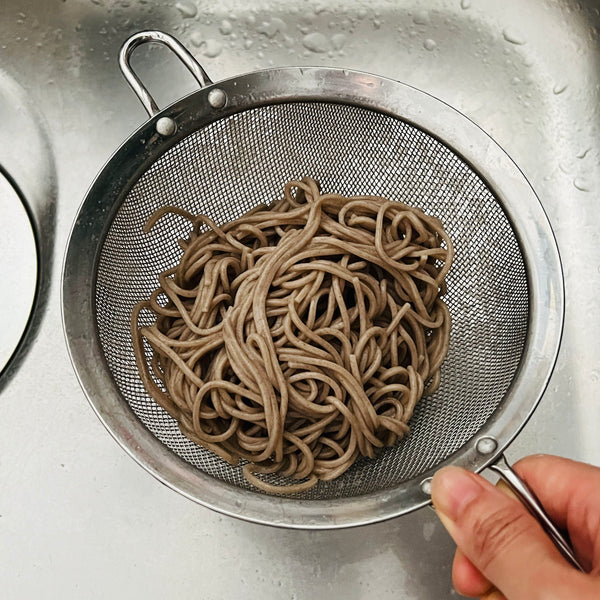 draining all of the excess water from the soba noodles