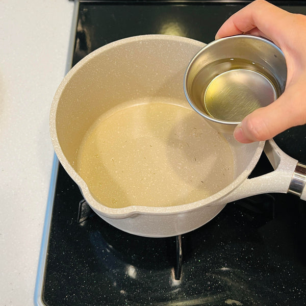 adding the cooking sake and mirin to a small pot