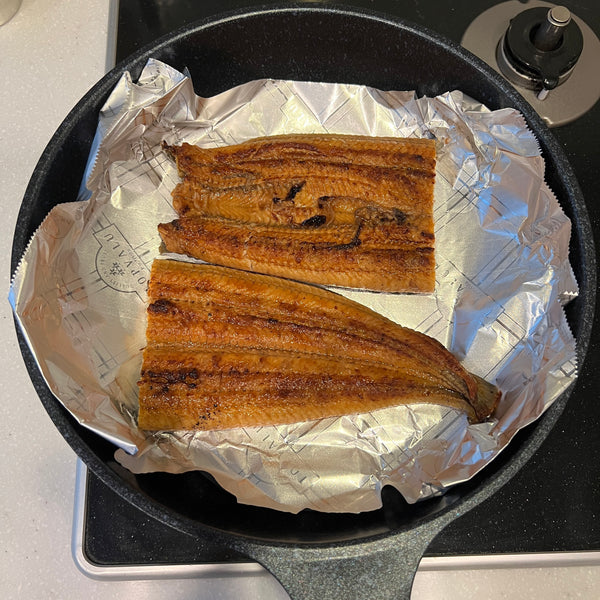 placing the unagi over a piece of foil in a frying pan