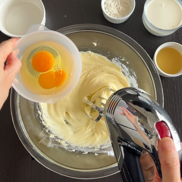 adding the eggs to the cream cheese mixture