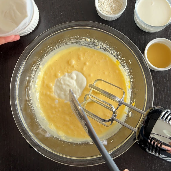 adding the yogurt to the cream cheese mixture