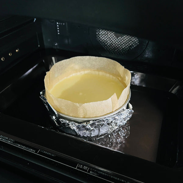 placing the yuzu cheesecake into the oven