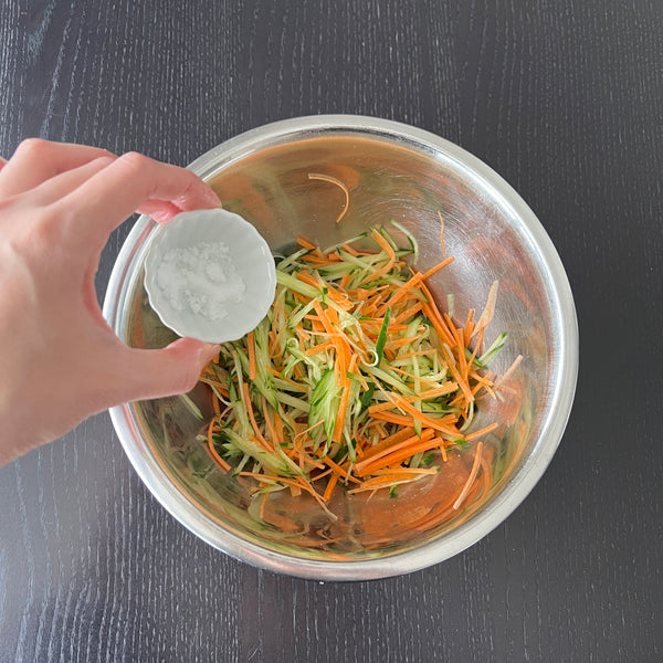 adding salt to the vegetables