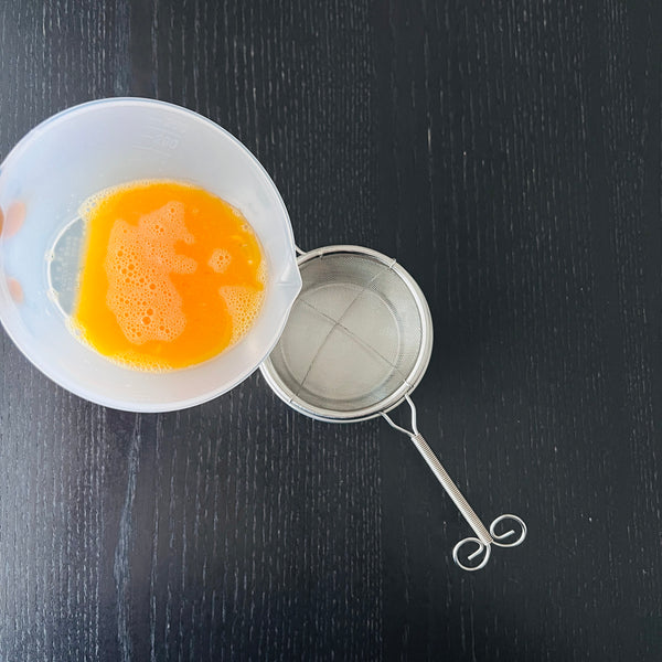 straining the eggs for better texture