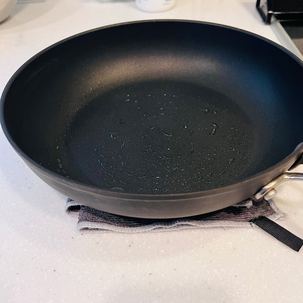 cooling the pan on a damp towel