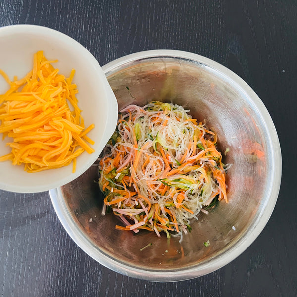 adding the kinshi tamago to the harusame salad