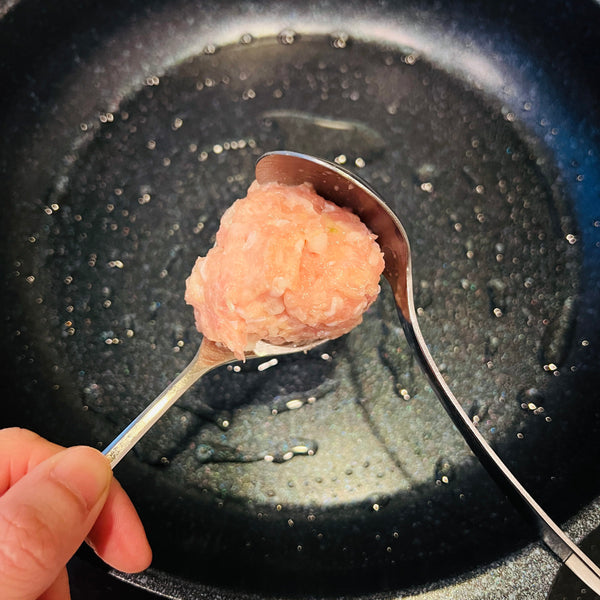 using two spoons to shape the tsukune