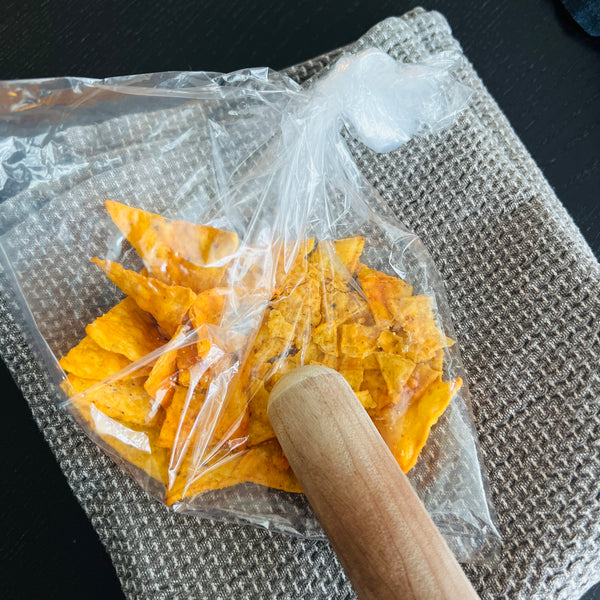 crushing the tortilla chips with a rolling pin